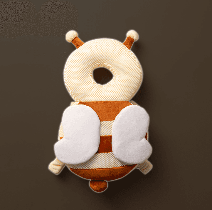 plush toy resembling a stylized bee is displayed against a solid grey background. The toy has a round body with stripes alternating in white and a warm brown color, two white wings attached to the back, two small, round white antennae on top of its head 