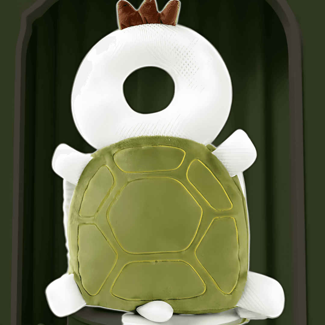 whimsical turtle plush toy with a white donut-shaped head topped with a brown crown sits on a reflective surface. The turtle's shell is green with yellow outlines, and it has white feet and tail. 