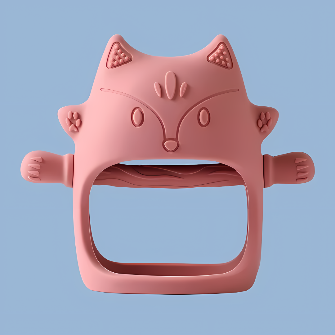 A red-colored, cat-shaped silicone baby teether, features embossed ears, eyes, nose, mouth, and whisker details, cat-shaped silicone, embossed design, silicone teether