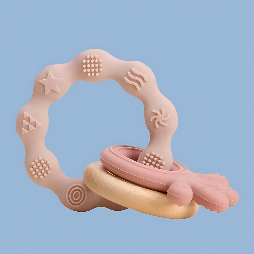 baby teether featuring a whimsical, abstract frame with various shapes and textures, frame includes elements such as stars, dots, swirls, and organic shapes in soft pink and beige tones, the design is playful and modern, suitable for toddlers in the early teething phase, side objects include a ring and octopus